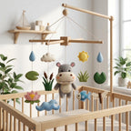 Handmade felt baby mobile featuring a central hippo, surrounded by lotus flowers, fish, dragonfly, pond plants, and raindrops hanging from a wooden frame over a baby crib, pond-themed nursery decor
