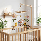 Handmade felt cow farm baby mobile with cow, sheep, chick, baby bottle, sunflower, flowers, and barn hanging above a wooden crib.