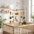 Handmade felt farm baby mobile with a chicken, chick, duck, wheat, tractor and nest hanging above a wooden crib.