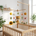 Handmade felt baby mobile featuring a central leopard, surrounded by sunflowers, the sun, butterflies, and green leaves hanging from a wooden frame over a baby crib, sunny safari-themed nursery decor