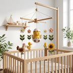 Handmade felt chick baby mobile with hatching chick, hen, duckling, flowers, sunflower, and wheat hanging above a wooden crib.