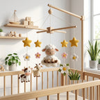 Handmade felt sheep baby mobile with lamb on a cloud, cow, goat, daisies, stars, and flowers hanging above a wooden crib.