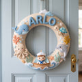 Handmade woodland felt baby mobile hanging above a wooden crib