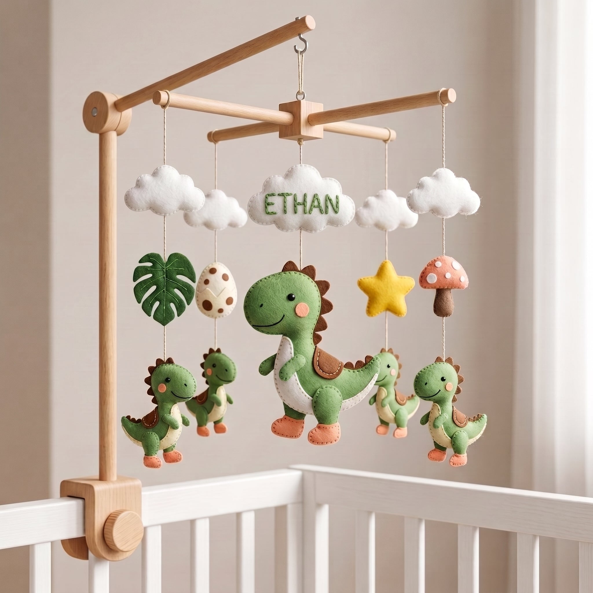 Handmade personalized dinosaur felt baby mobile above a white crib