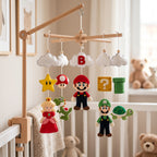 Handmade gaming inspired felt baby mobile with colorful game characters hanging on a wooden X-frame above a baby crib.